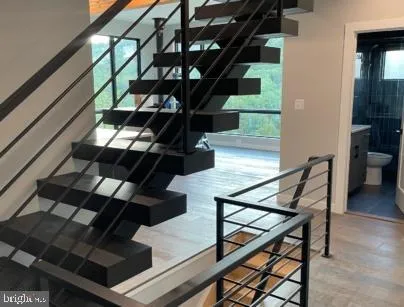 a view of entryway and hall with wooden floor