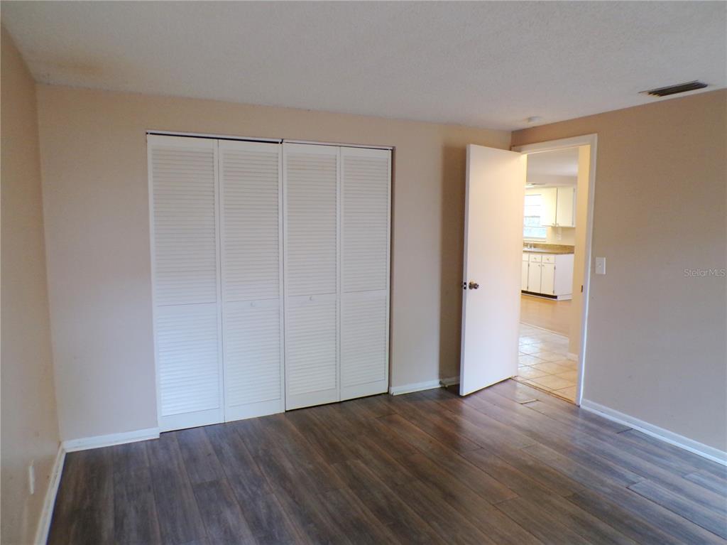 1123 Foggy Ridge Parkway Lutz, FL 33559 - Photo 11 of 18 a view of an empty room with wooden floor and a window