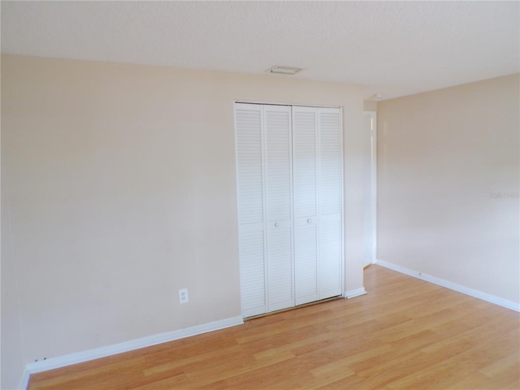 1123 Foggy Ridge Parkway Lutz, FL 33559 - Photo 14 of 18 a view of an empty room and wooden floor