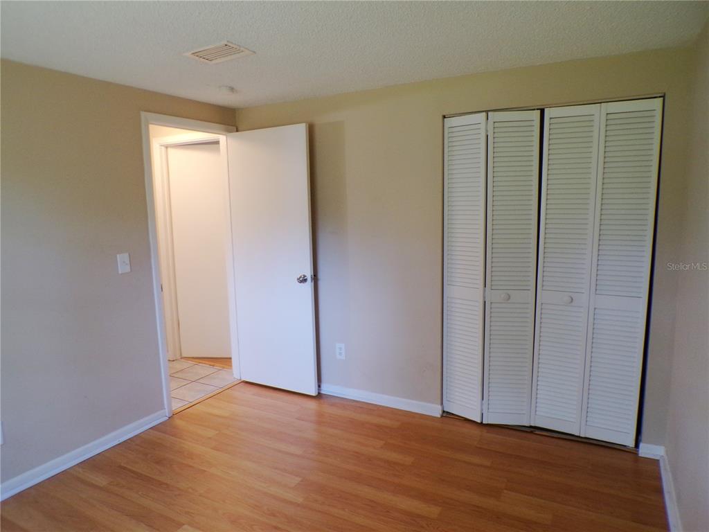 1123 Foggy Ridge Parkway Lutz, FL 33559 - Photo 17 of 18 a view of an empty room with wooden floor