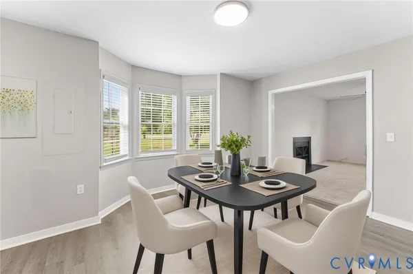 a view of a dining room with furniture and window