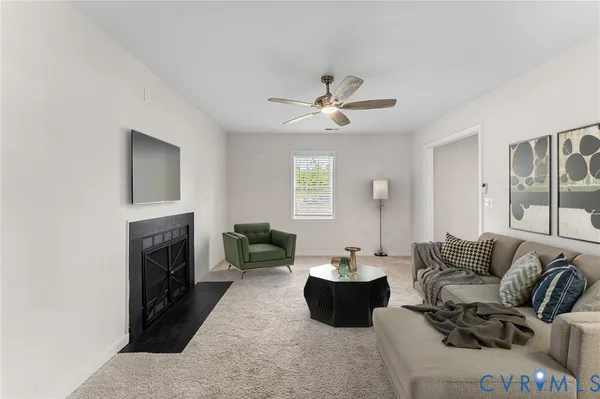 a living room with furniture fireplace and a window