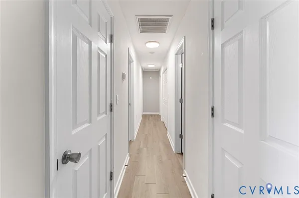 a view of a bathroom from a hallway