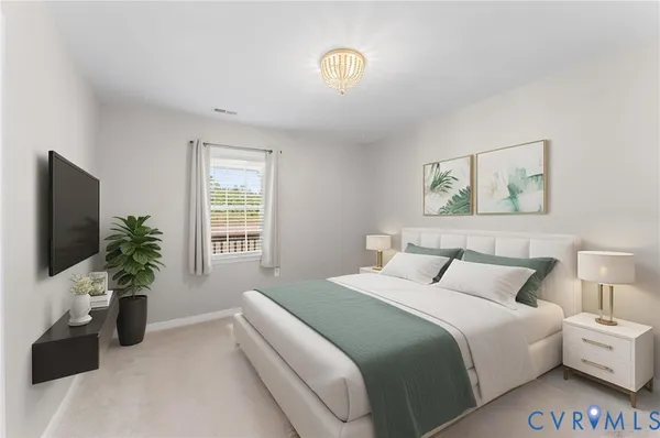 a bedroom with a bed and a potted plant