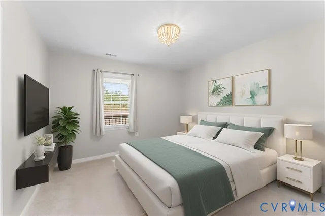 a bedroom with a bed and a potted plant