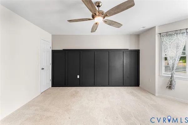 a view of a room with a ceiling fan
