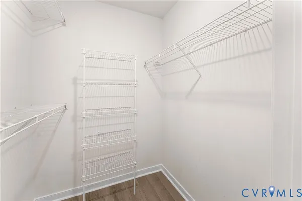 a view of walk in closet with empty racks
