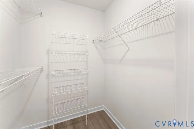 a view of walk in closet with empty racks