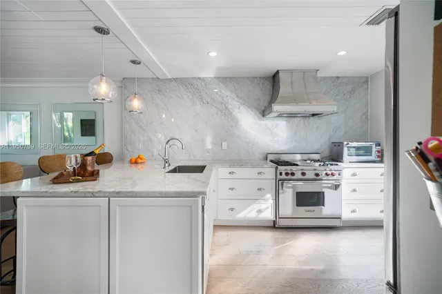 a kitchen with cabinets appliances and a sink