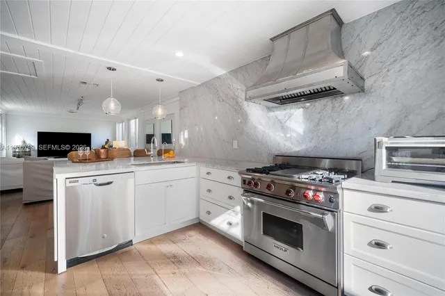a kitchen with a stove and white cabinets
