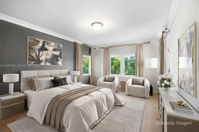 a bedroom with furniture and large windows