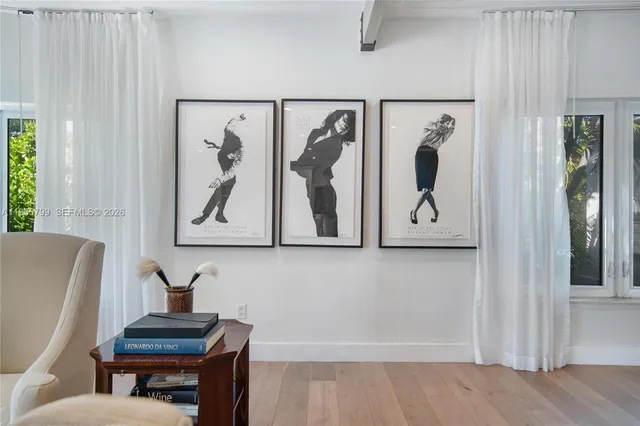 a bathroom with a bathtub and a painting on the wall