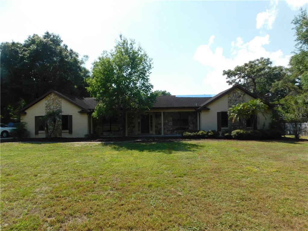 2310 South Valrico Road Valrico, FL 33596 - Photo 1 of 1 a front view of house with yard and trees in the background