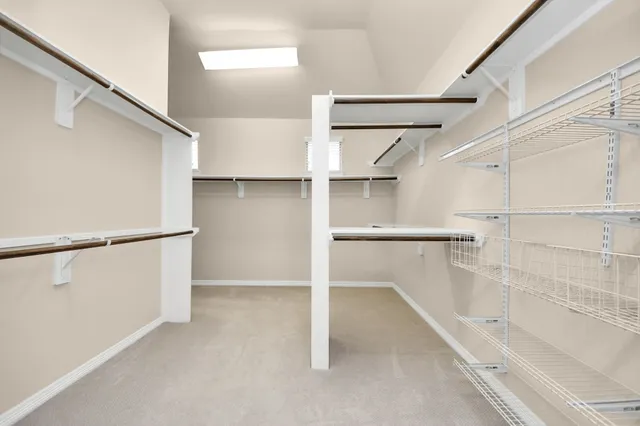 a view of a house with a wooden fence