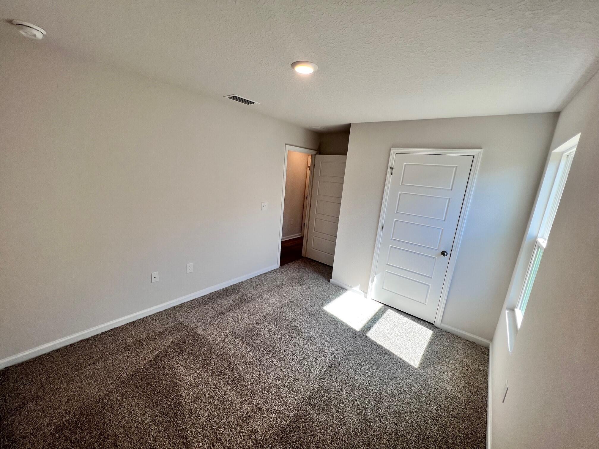 3101 Van Day Way Crestview, FL 32539 - Photo 7 of 26 an empty room with windows