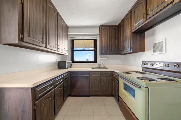 a kitchen with stainless steel appliances granite countertop a sink stove and cabinets