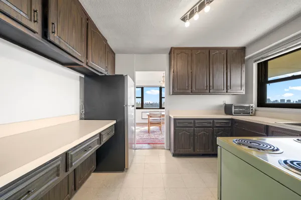 a kitchen with a stove sink and cabinets