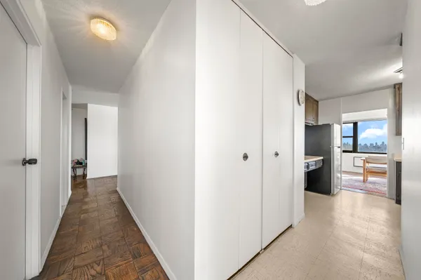 a view of a hallway view with wooden floor and windows