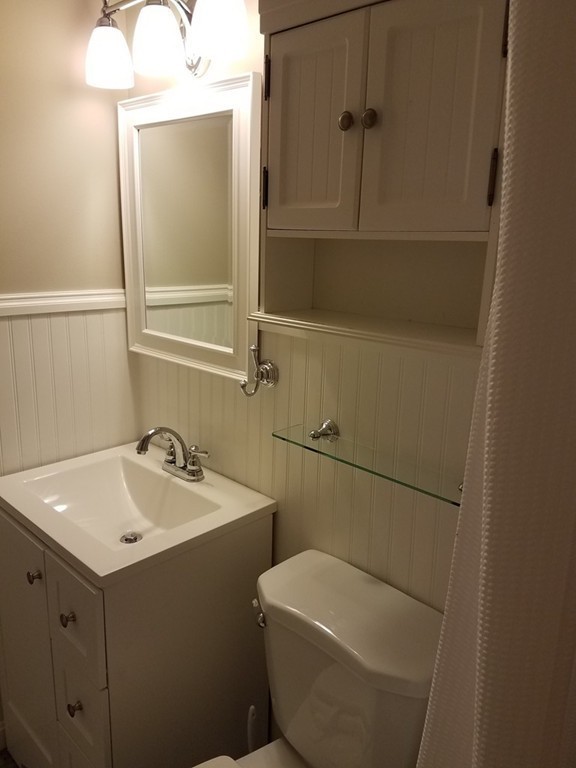 549 Pine Street, Unit 1 Lowell, MA 01851 - Photo 12 of 12 a bathroom with a sink and mirror