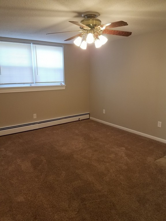 549 Pine Street, Unit 1 Lowell, MA 01851 - Photo 4 of 12 an empty room with a window