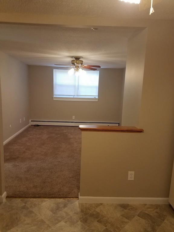 549 Pine Street, Unit 1 Lowell, MA 01851 - Photo 5 of 12 a view of a room with an empty space