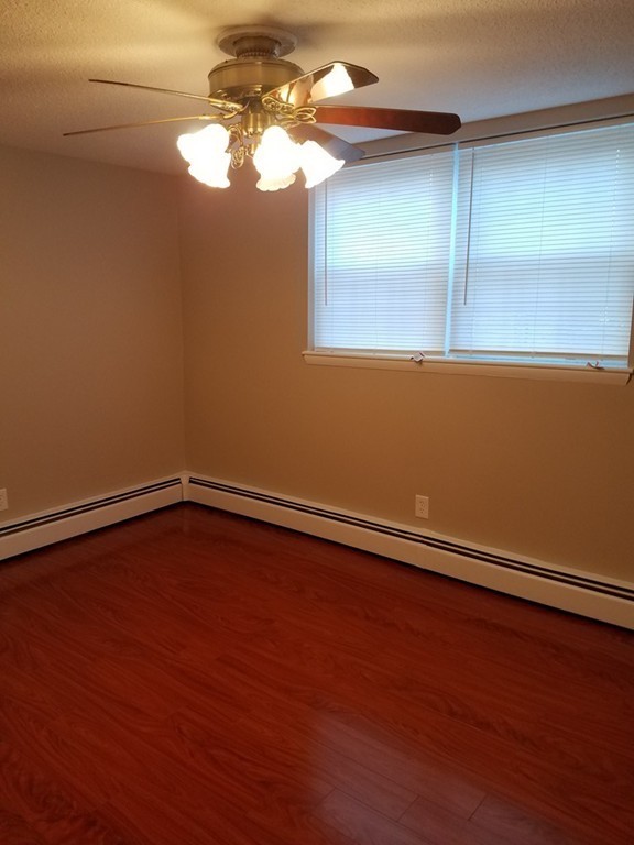 549 Pine Street, Unit 1 Lowell, MA 01851 - Photo 7 of 12 a view of a room with wooden floor