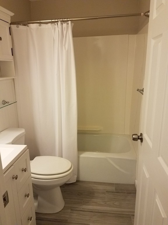 549 Pine Street, Unit 1 Lowell, MA 01851 - Photo 10 of 12 a bathroom with a toilet and shower