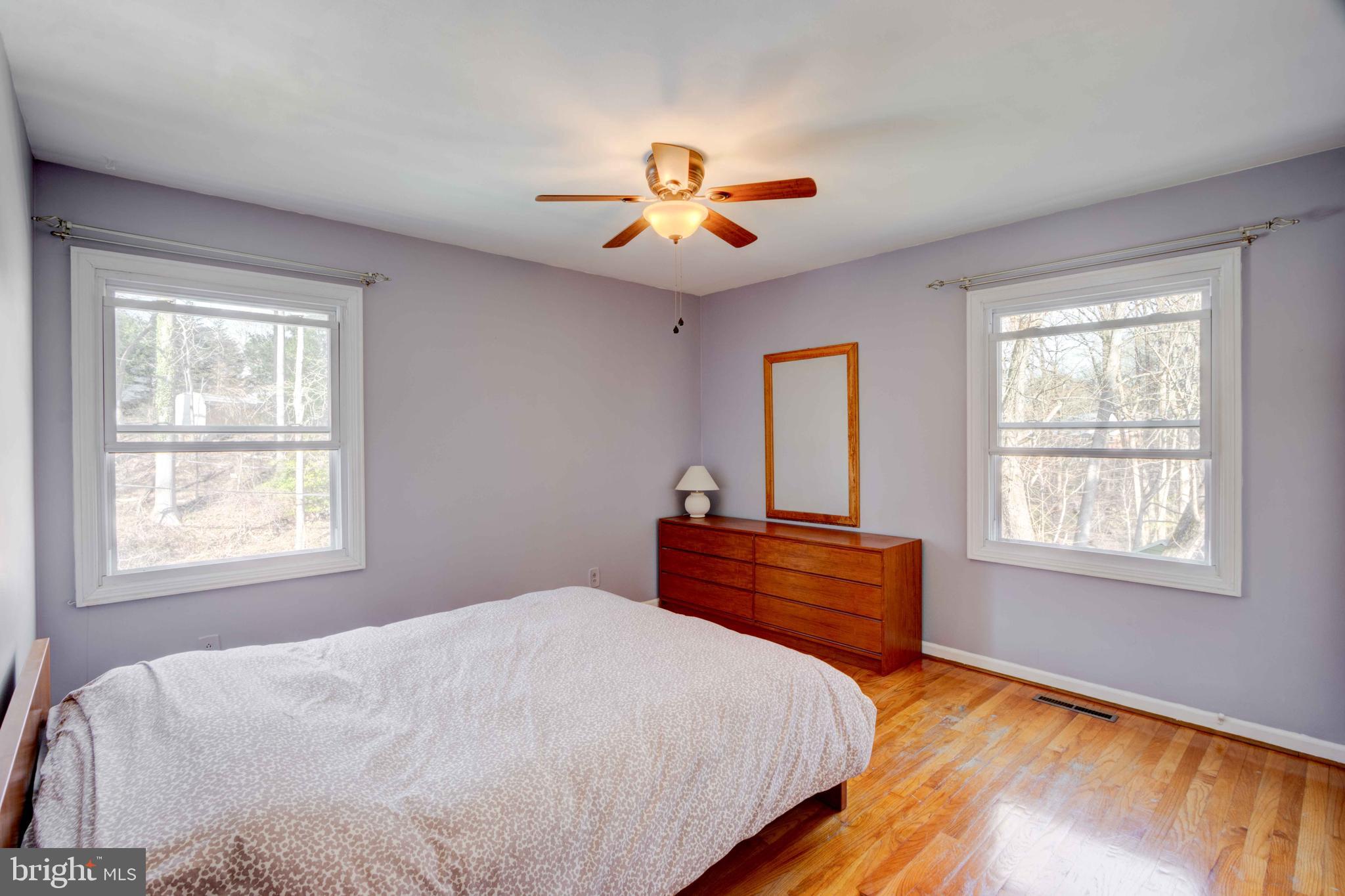 1320 Denby Road Towson, MD 21286 - Photo 24 of 39 a bedroom with a large bed and a chandelier