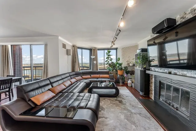 a living room with furniture fireplace and flat screen tv