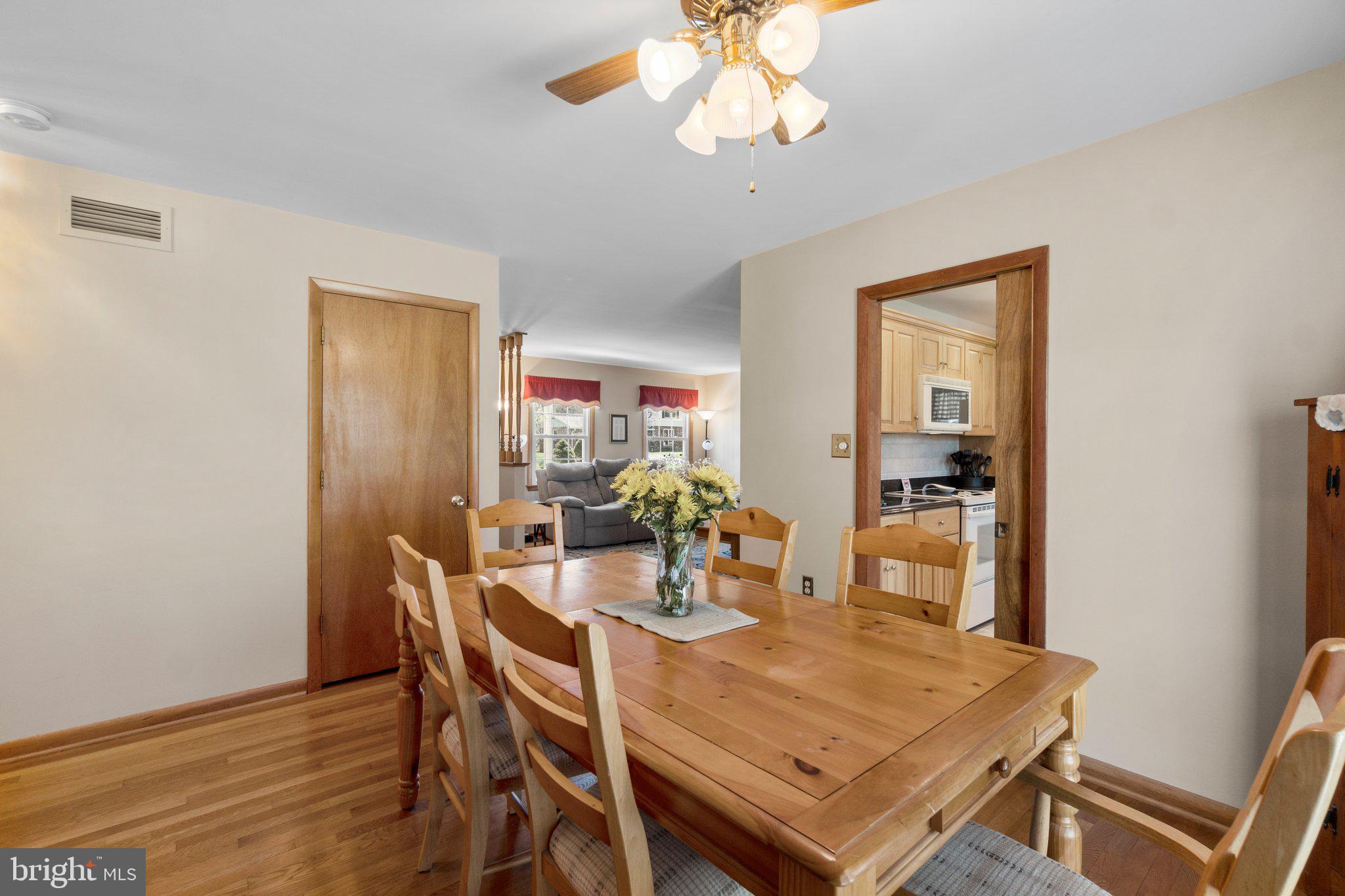 8008 Meadowview Drive Frederick, MD 21702 - Photo 11 of 42 a view of a dining room with furniture and wooden floor