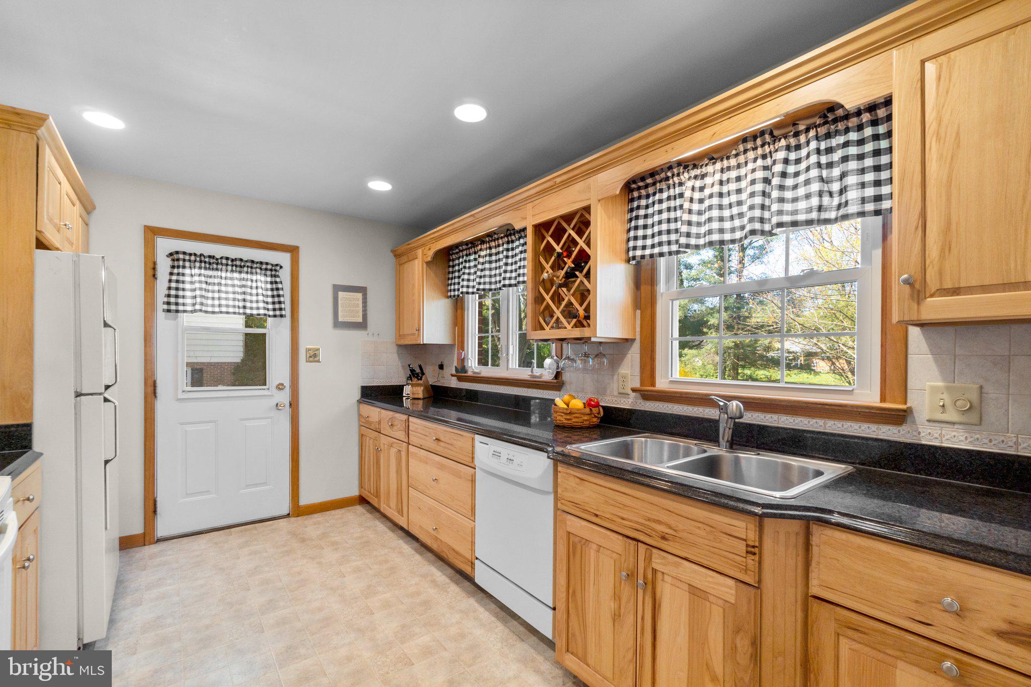 8008 Meadowview Drive Frederick, MD 21702 - Photo 12 of 42 a kitchen with stainless steel appliances granite countertop a sink and a window