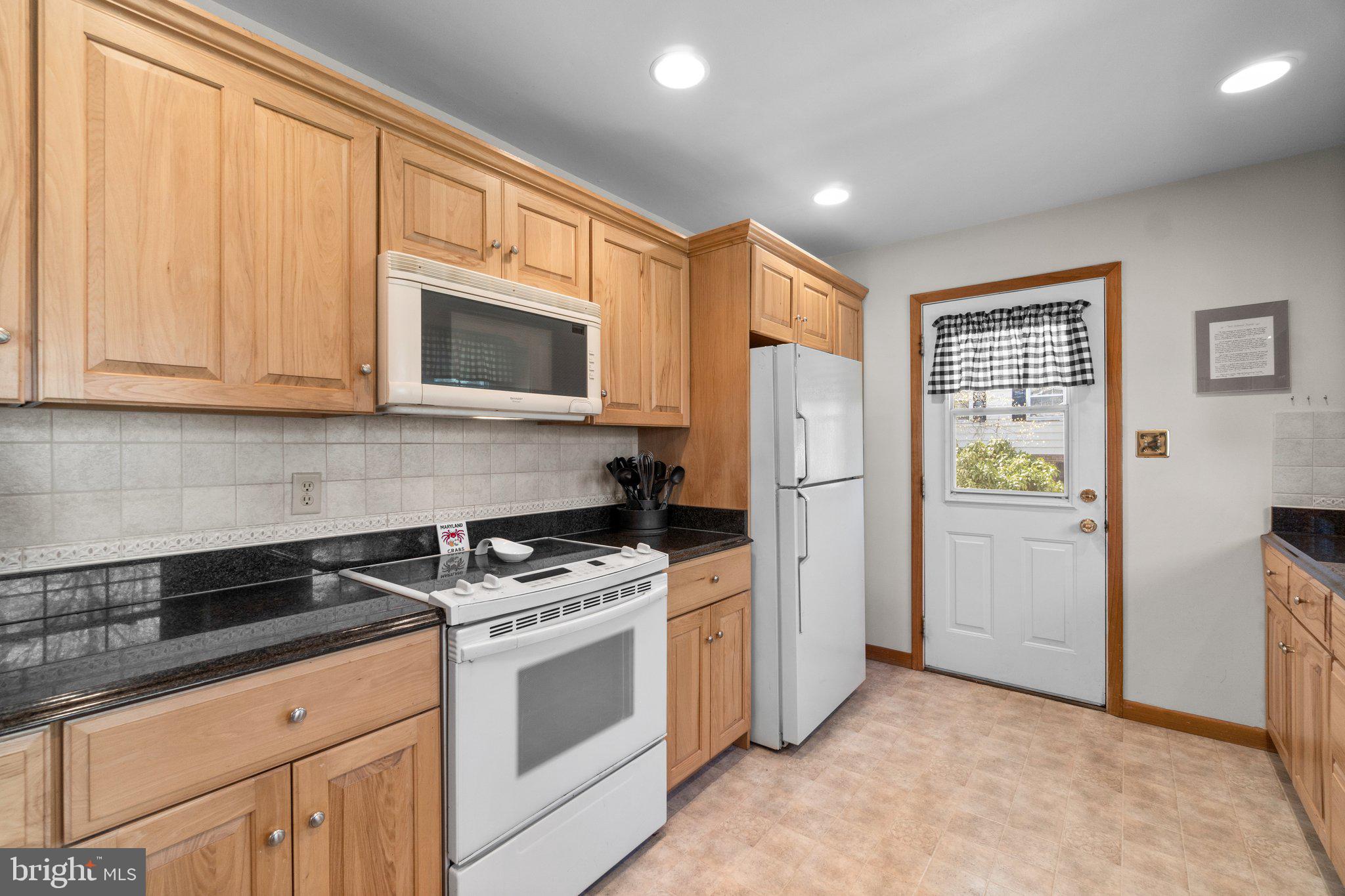 8008 Meadowview Drive Frederick, MD 21702 - Photo 14 of 42 a kitchen with stainless steel appliances granite countertop a refrigerator sink and stove
