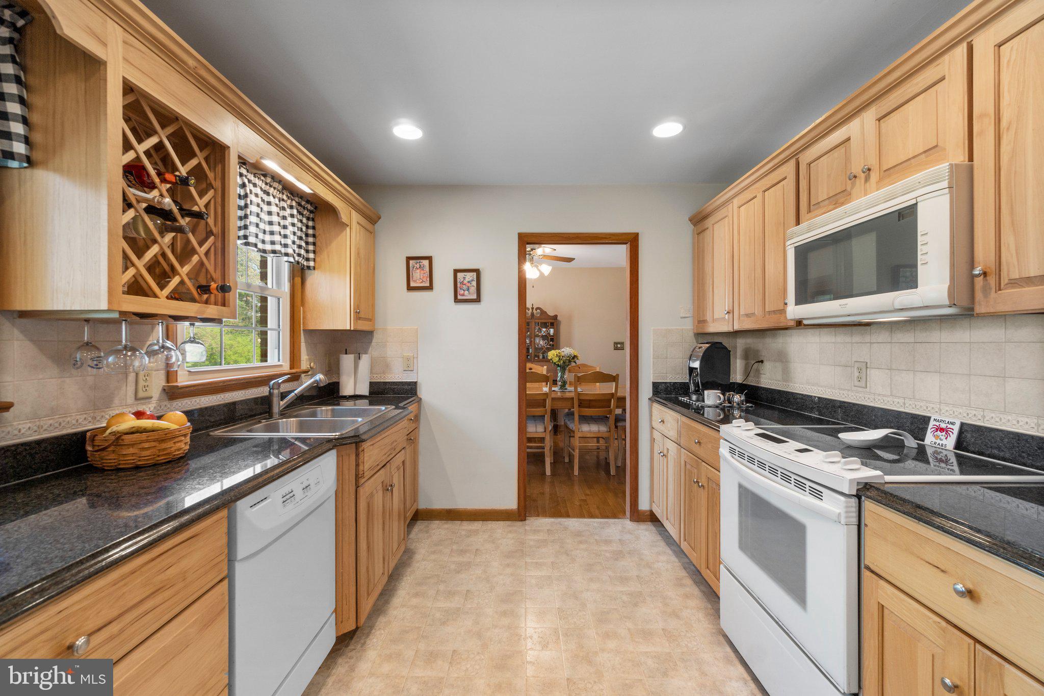 8008 Meadowview Drive Frederick, MD 21702 - Photo 16 of 42 a kitchen with stainless steel appliances granite countertop a stove a sink and a microwave