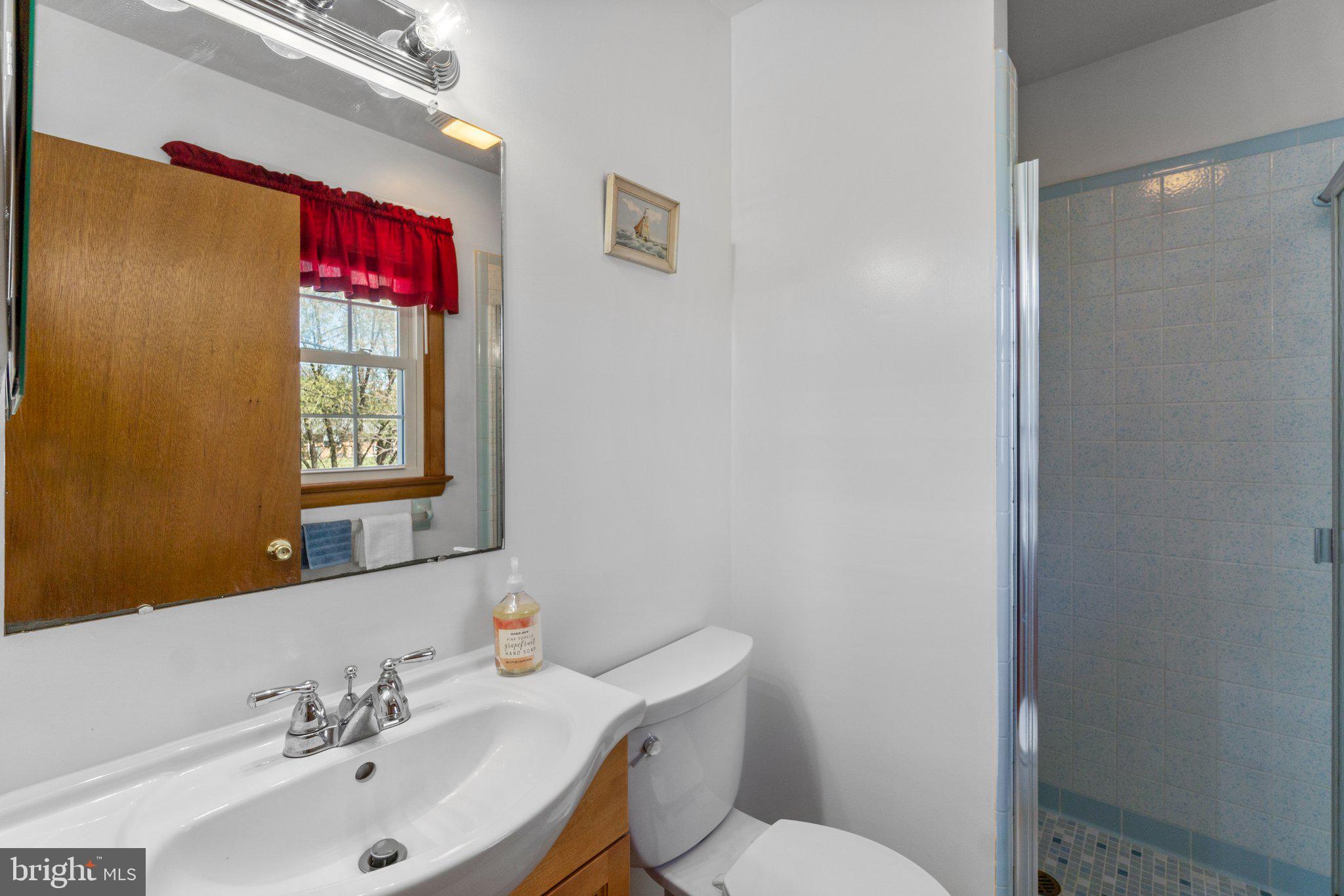 8008 Meadowview Drive Frederick, MD 21702 - Photo 21 of 42 a bathroom with a toilet sink and mirror