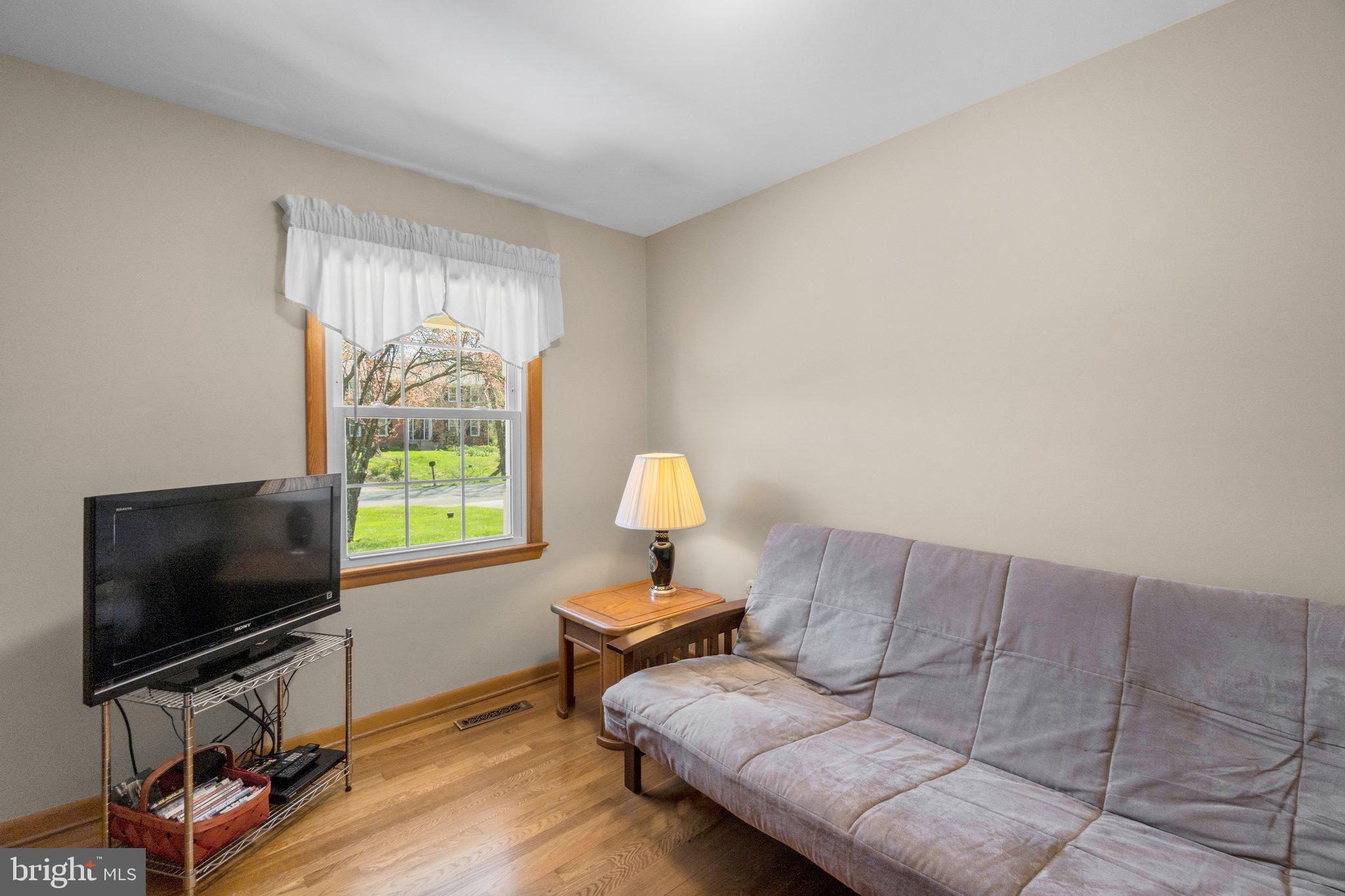 8008 Meadowview Drive Frederick, MD 21702 - Photo 24 of 42 a living room with furniture and a flat screen tv