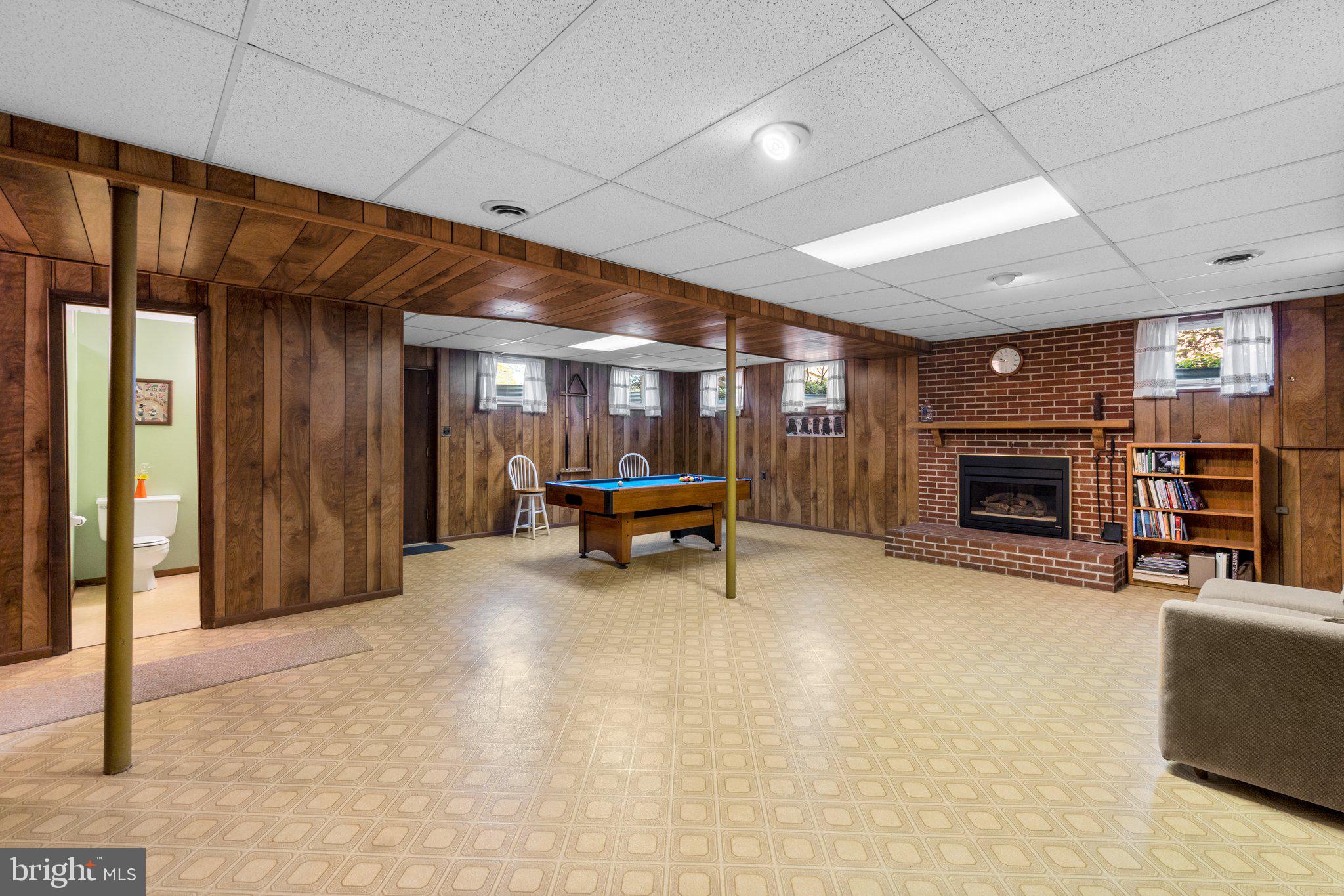 8008 Meadowview Drive Frederick, MD 21702 - Photo 31 of 42 a living room with furniture a fireplace and a ceiling fan