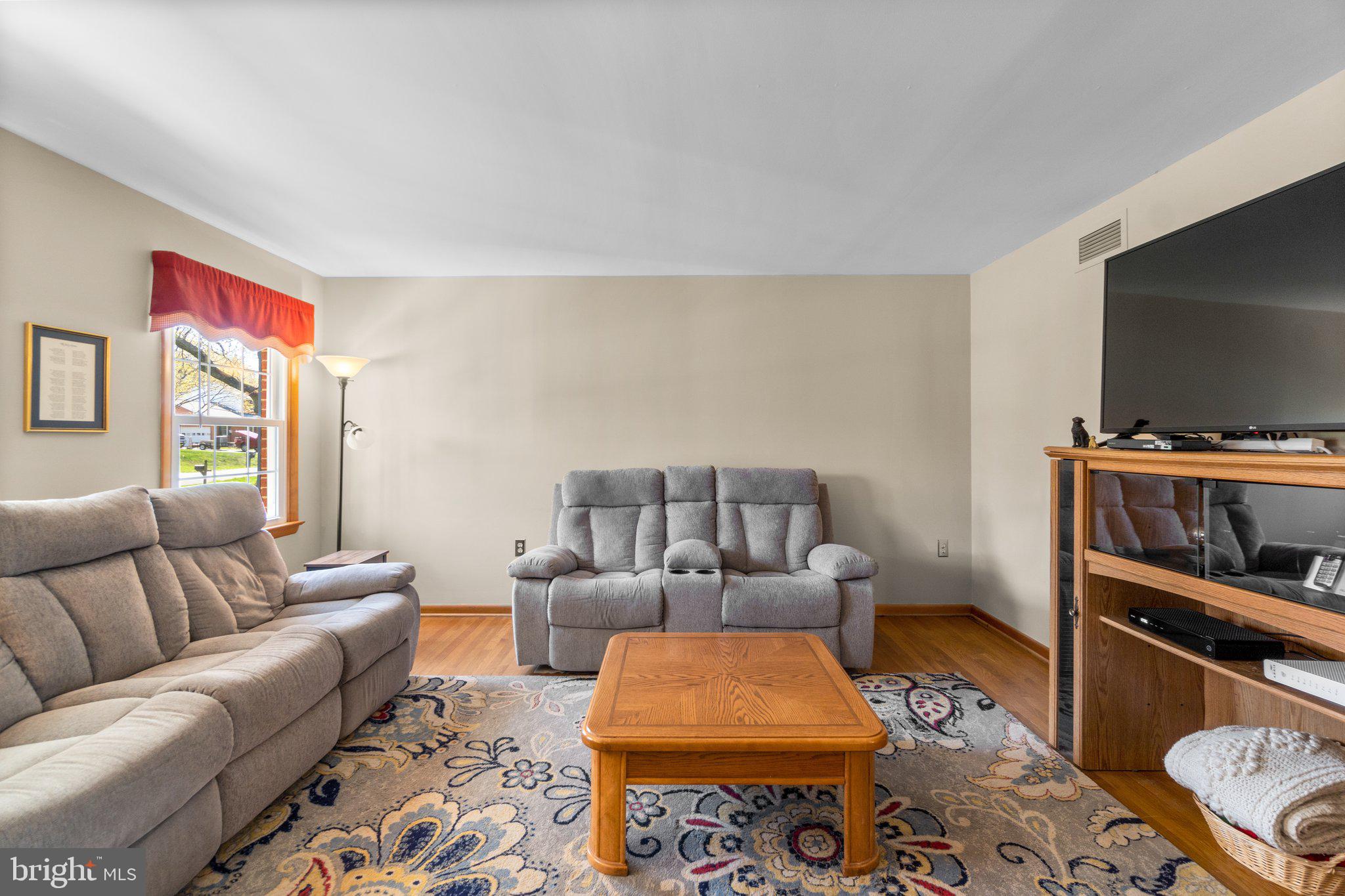 8008 Meadowview Drive Frederick, MD 21702 - Photo 5 of 42 a living room with furniture and a flat screen tv