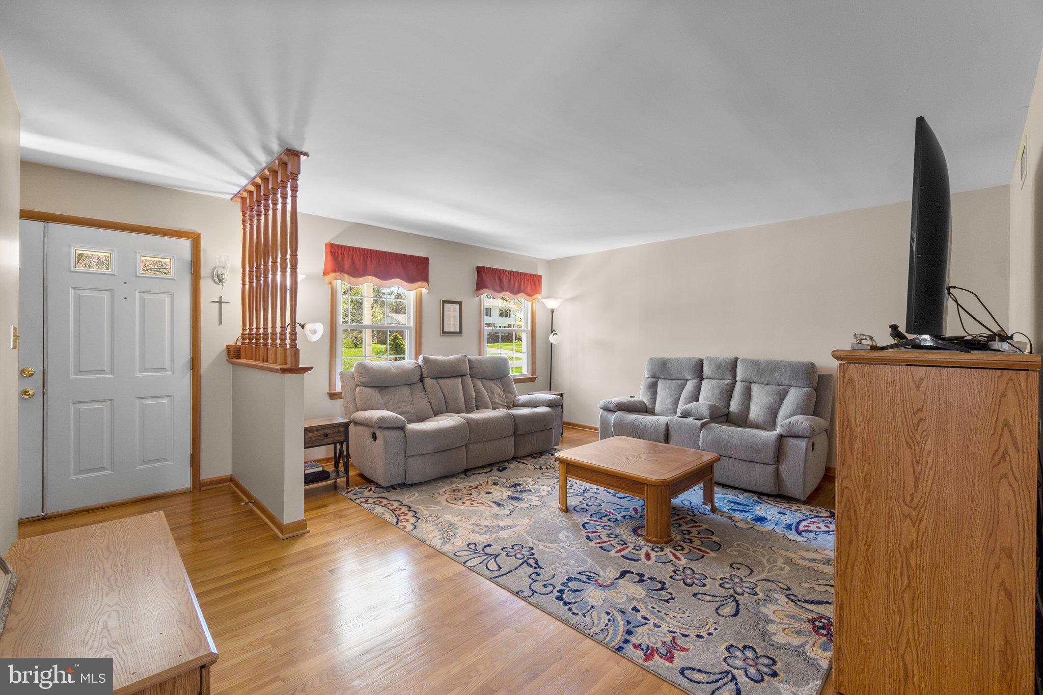 8008 Meadowview Drive Frederick, MD 21702 - Photo 6 of 42 a living room with furniture and a flat screen tv