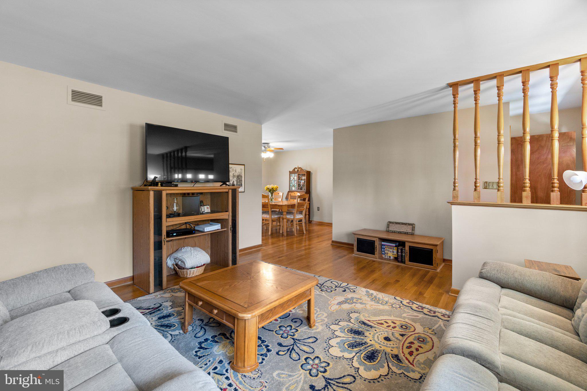 8008 Meadowview Drive Frederick, MD 21702 - Photo 8 of 42 a living room with furniture a flat screen tv and a refrigerator