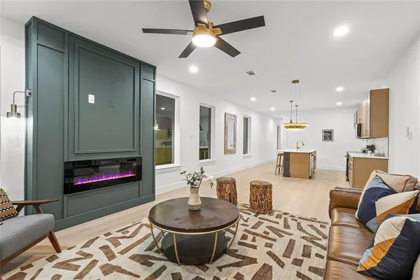 a living room with furniture and a wooden floor
