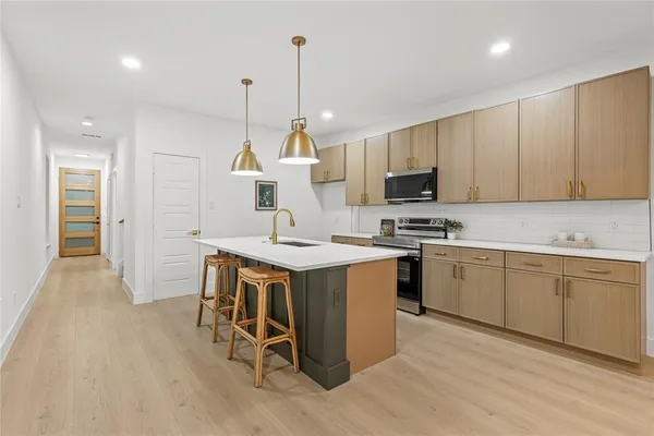 a kitchen with a sink a microwave and cabinets