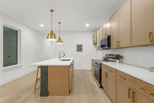 a kitchen with a sink appliances and cabinets