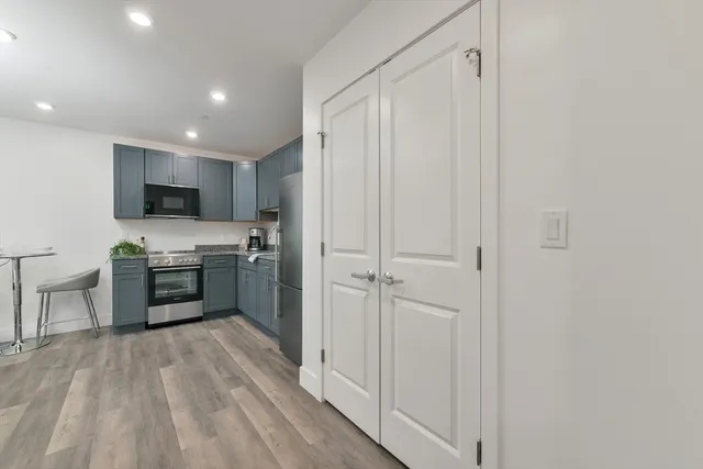 a kitchen with stainless steel appliances a refrigerator and a stove top oven