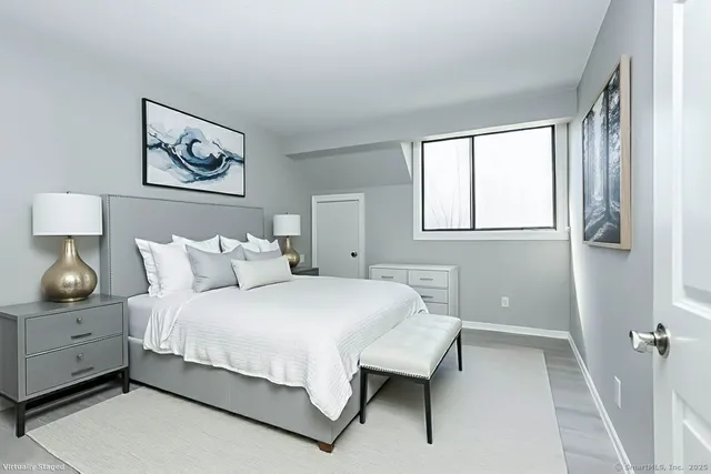 a bedroom with a bed and window