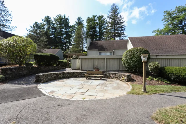 a view of a house with backyard and sitting area