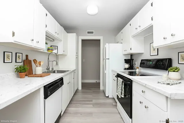 a kitchen with a sink stove and refrigerator