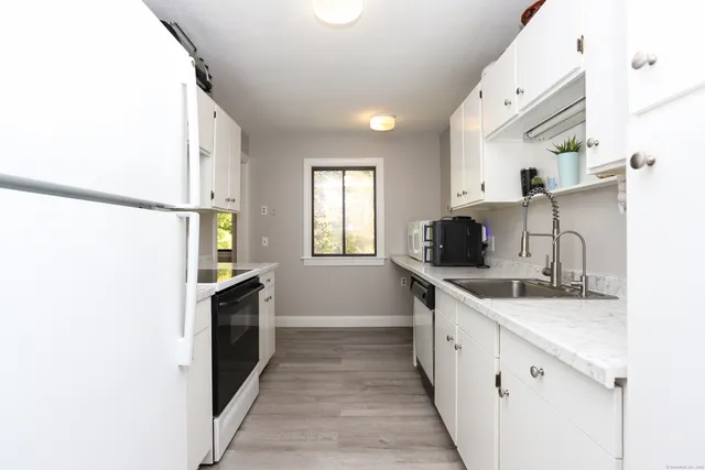 a kitchen with a sink and a refrigerator