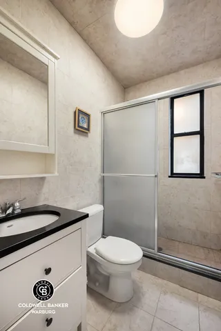 a bathroom with a toilet a sink and shower