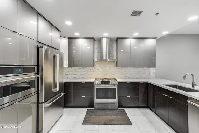 a kitchen with stainless steel appliances granite countertop a sink and stove