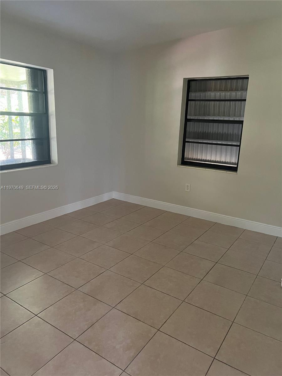 14435 Southwest 289th Street Homestead, FL 33033 - Photo 8 of 18 an empty room with windows